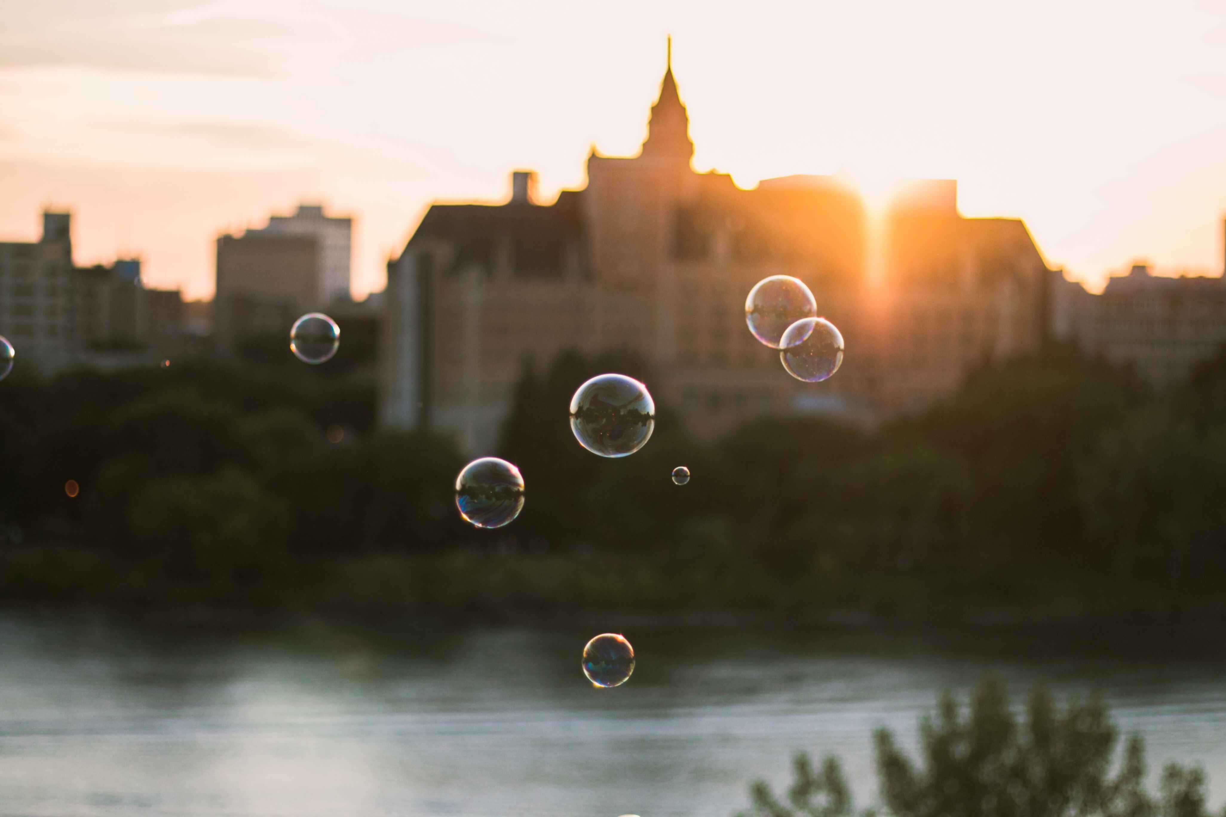 Bubbles floating in the foreground of a beautiful landscape